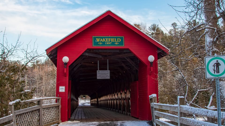 A red covered bridge with a sign reading "Wakefield 1997".