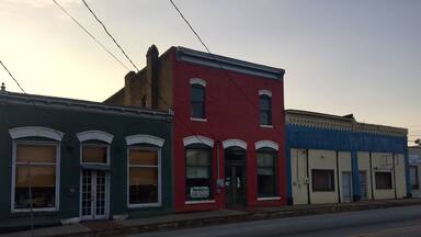 A row of colorful buildings along a street.