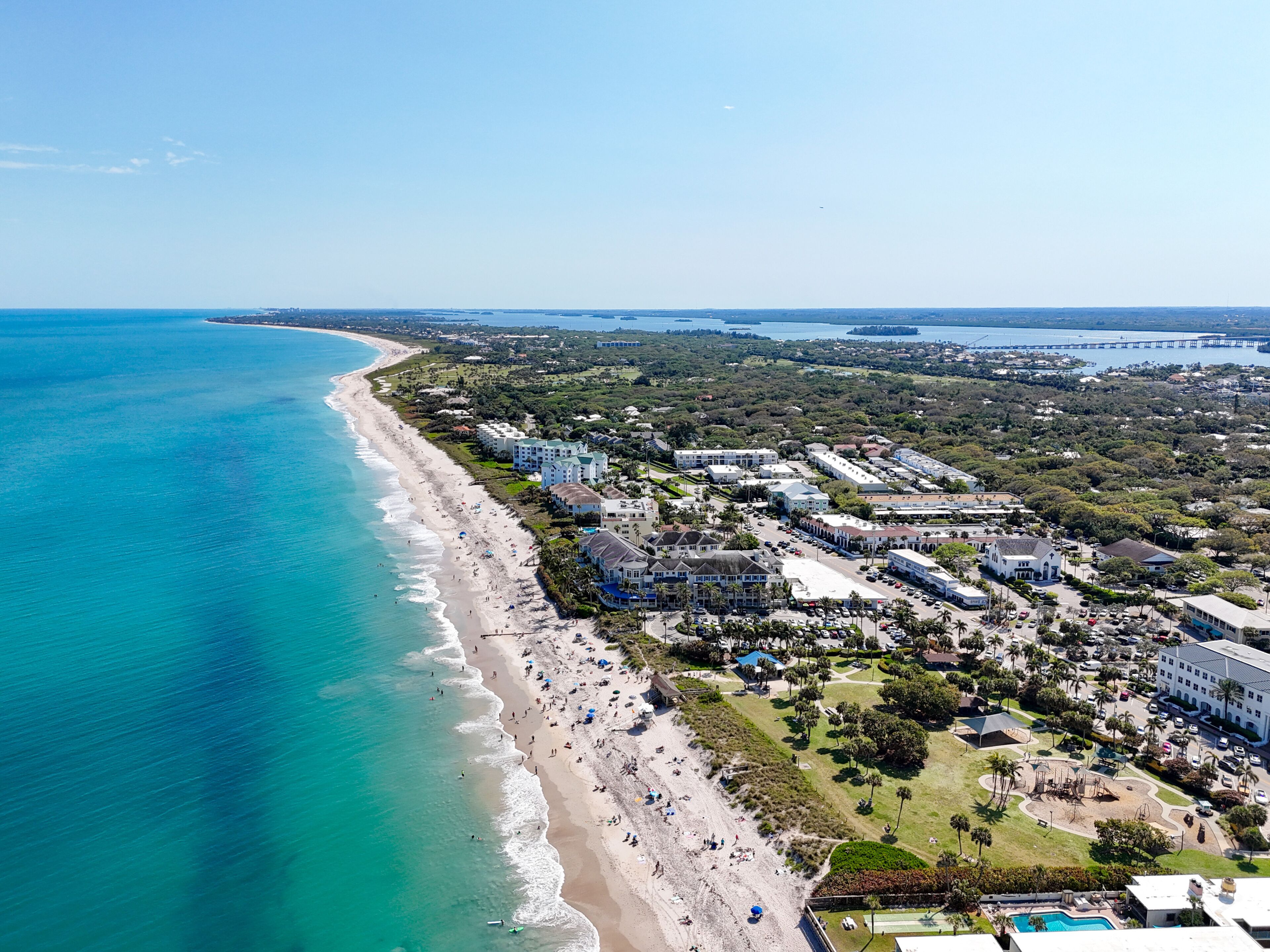 Aerial view along the coastline on a beautiful sunny summer beach day in Vero Beach located in Indian River County, Florida.