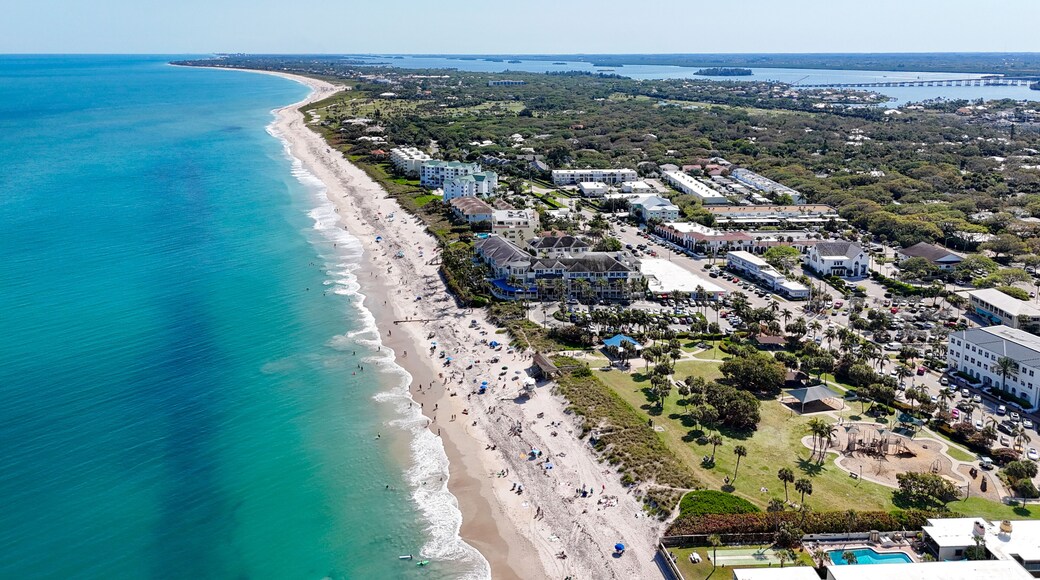 Aerial view along the coastline on a beautiful sunny summer beach day in Vero Beach located in Indian River County, Florida.