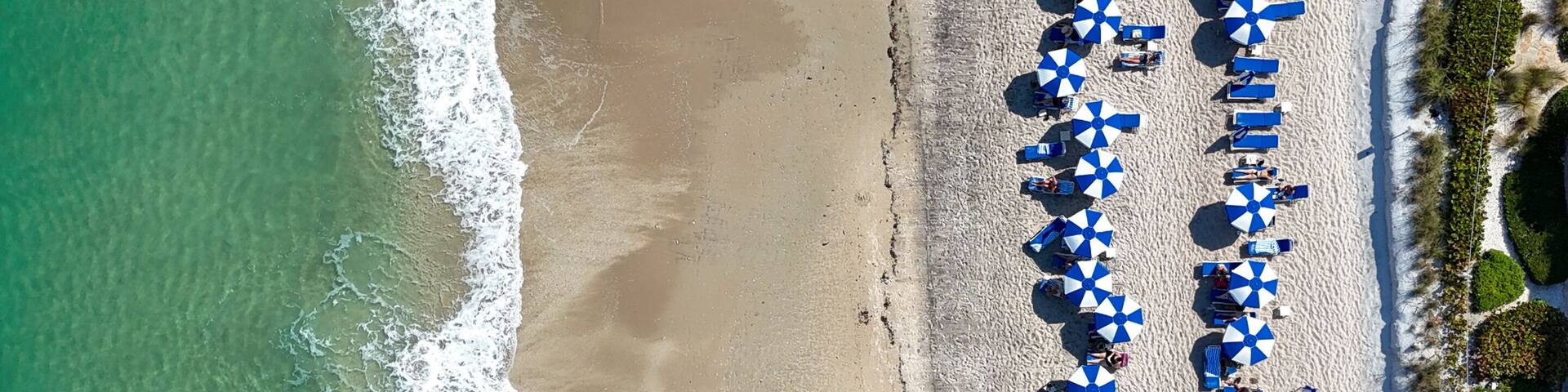 Sunbathers enjoying a sunny beach day at Vero Beach, Florida in Indian River County.