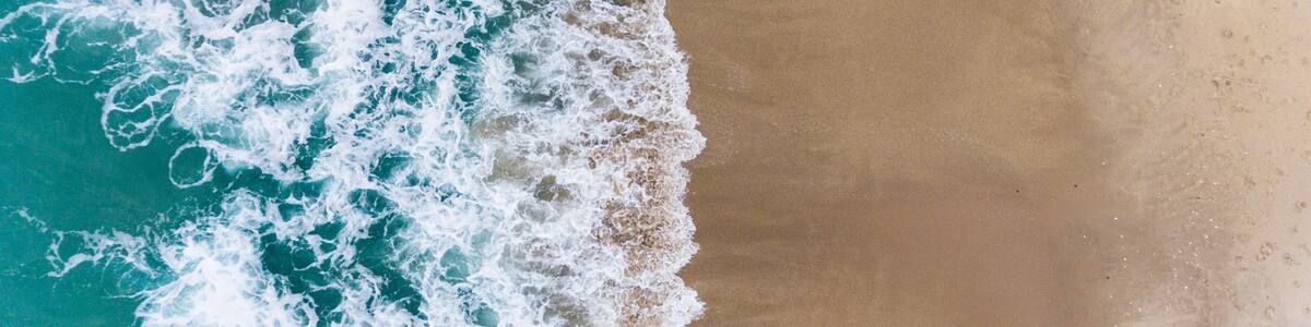 A beach with waves crashing onto the shore.