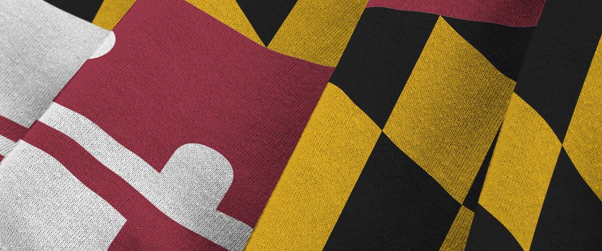 Maryland US state flag with big folds waving close up under the studio light indoors. The official symbols and colors in fabric banner