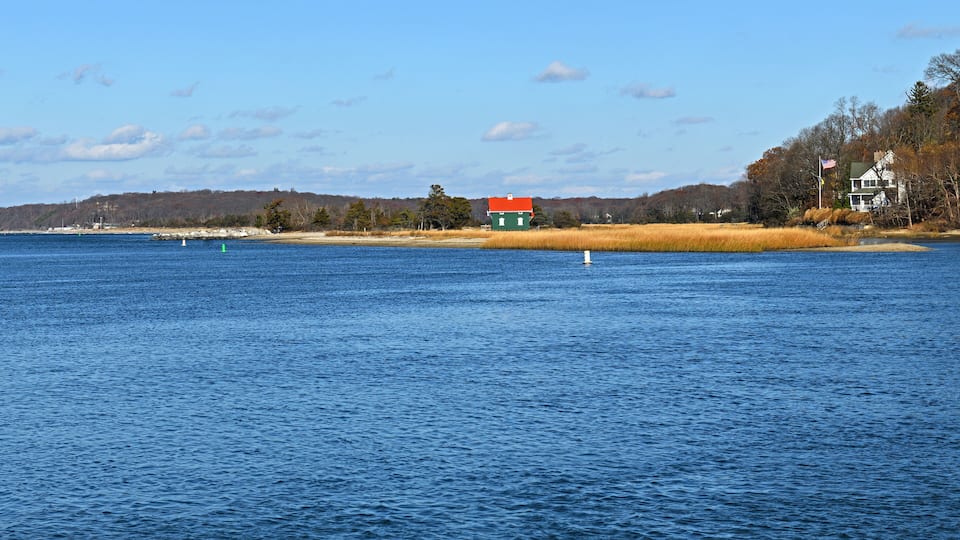 Autumn landscape with Gamecock Cottage, historic building, at Stony Brook in Brookhaven Town, in Suffolk County, New York, on Long Island