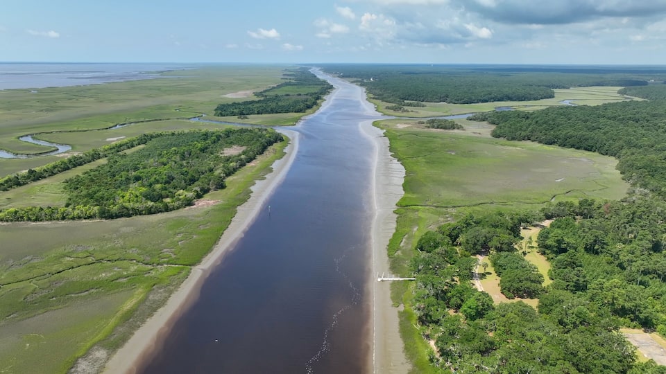 A river winding through a landscape with dense forests and open fields.