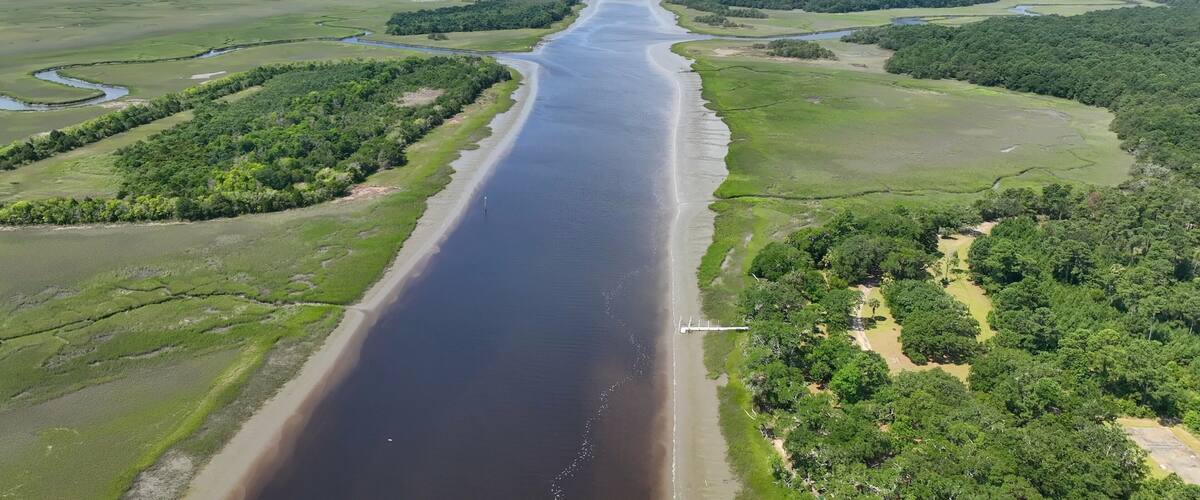 A river winding through a landscape with dense forests and open fields.