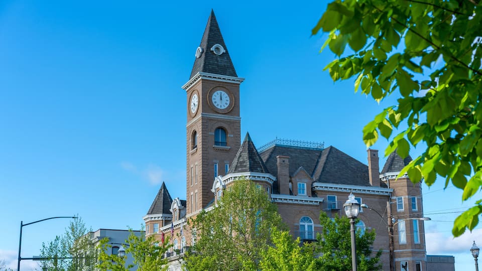 A historic building with a clock tower and a turret.