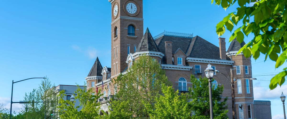 A historic building with a clock tower and a turret.