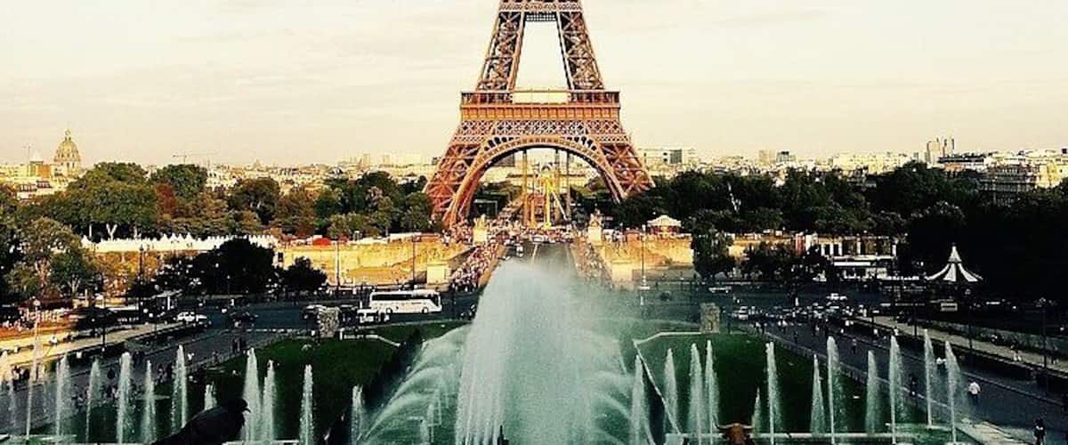 The Eiffel Tower with a fountain in the foreground.