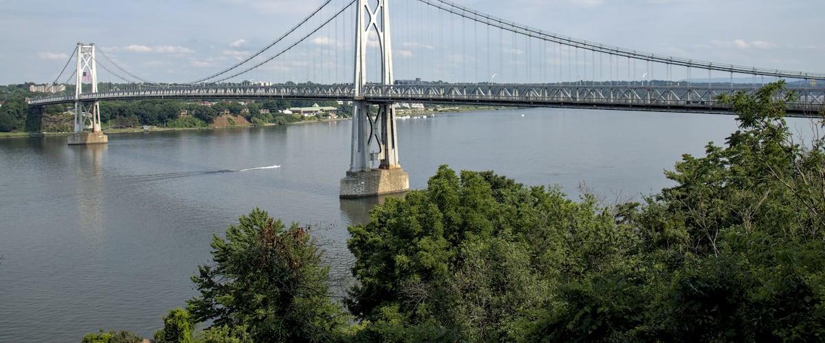 view of the mid hudson bridge to poughkeepsie, new york from highland (suspension bridge over river crossing) scenic landmark (pedestian and bike path, car lanes highway) valley ny state detail