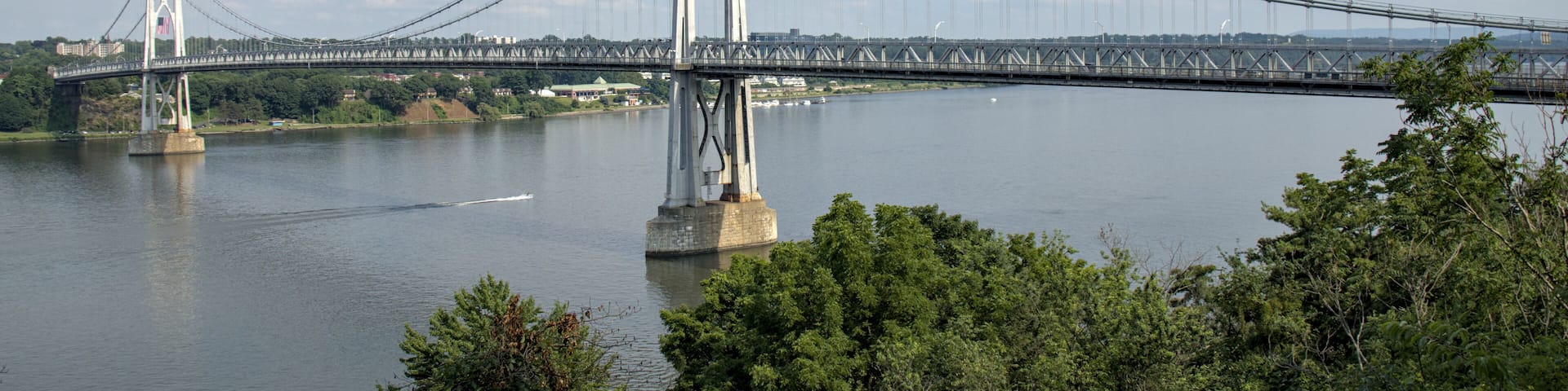view of the mid hudson bridge to poughkeepsie, new york from highland (suspension bridge over river crossing) scenic landmark (pedestian and bike path, car lanes highway) valley ny state detail