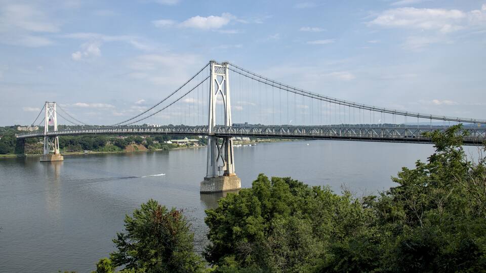 view of the mid hudson bridge to poughkeepsie, new york from highland (suspension bridge over river crossing) scenic landmark (pedestian and bike path, car lanes highway) valley ny state detail