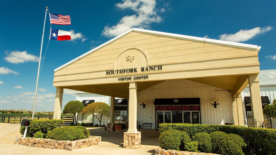 The Southfork Ranch Visitor Center with a Texas flag.