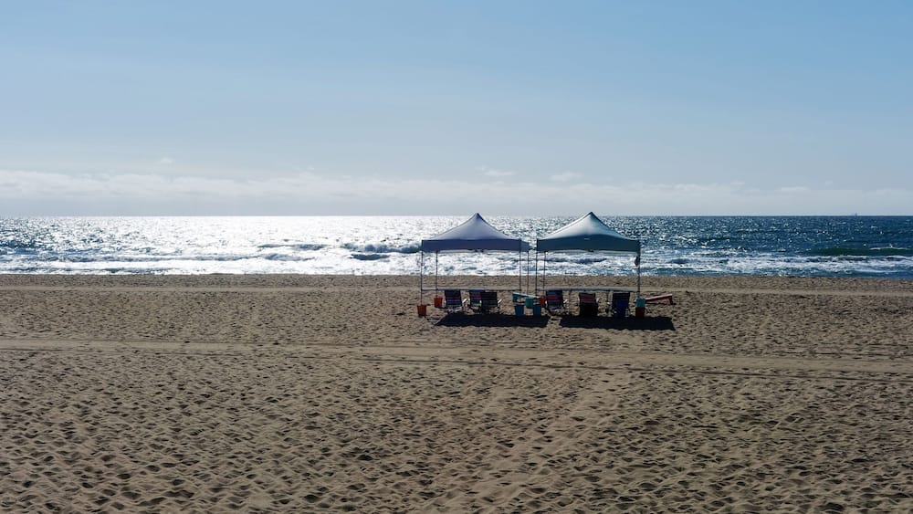 Early morning beach seascape with tents.