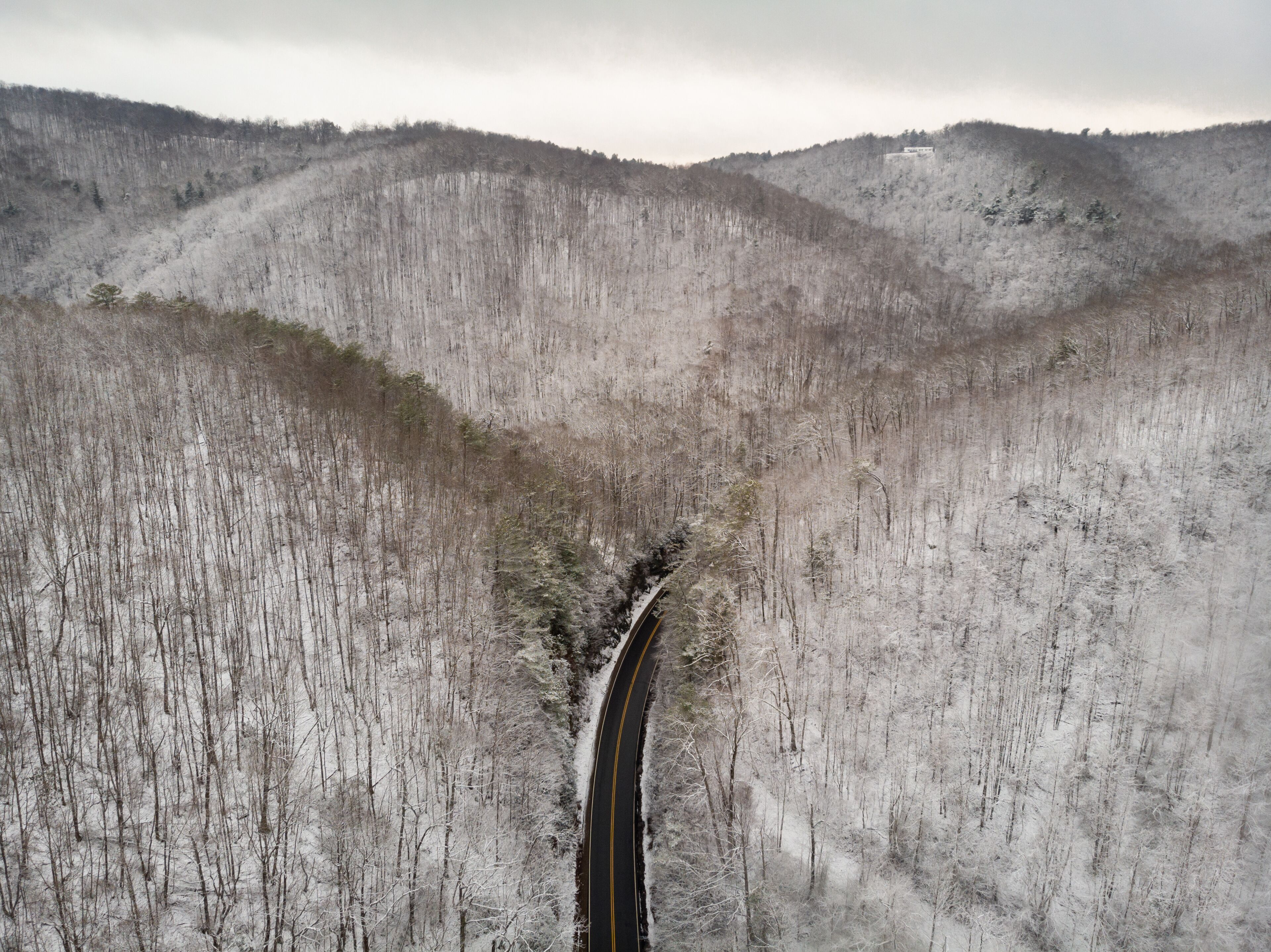 Aerial View of Winding North Carolina Mountain Road in the Snow