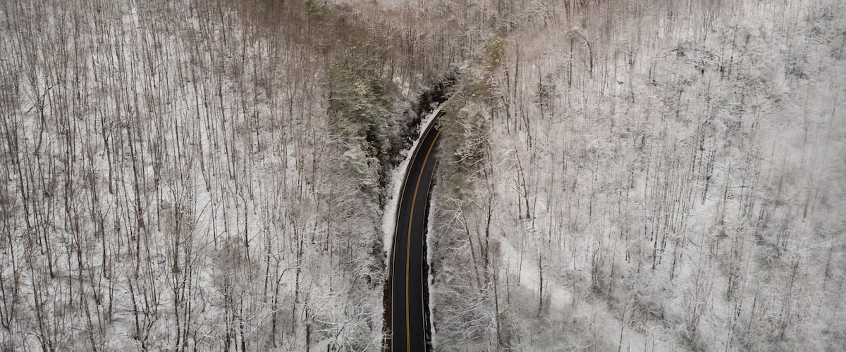 Aerial View of Winding North Carolina Mountain Road in the Snow