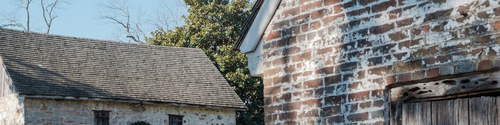 Brick walls and wooden barn doors in a small colonial town
