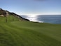 A golf course with a view of the ocean.