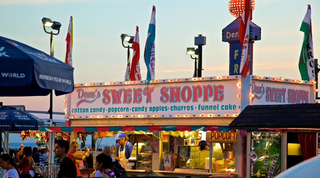 Riegelmann Boardwalk which includes signage and a sunset