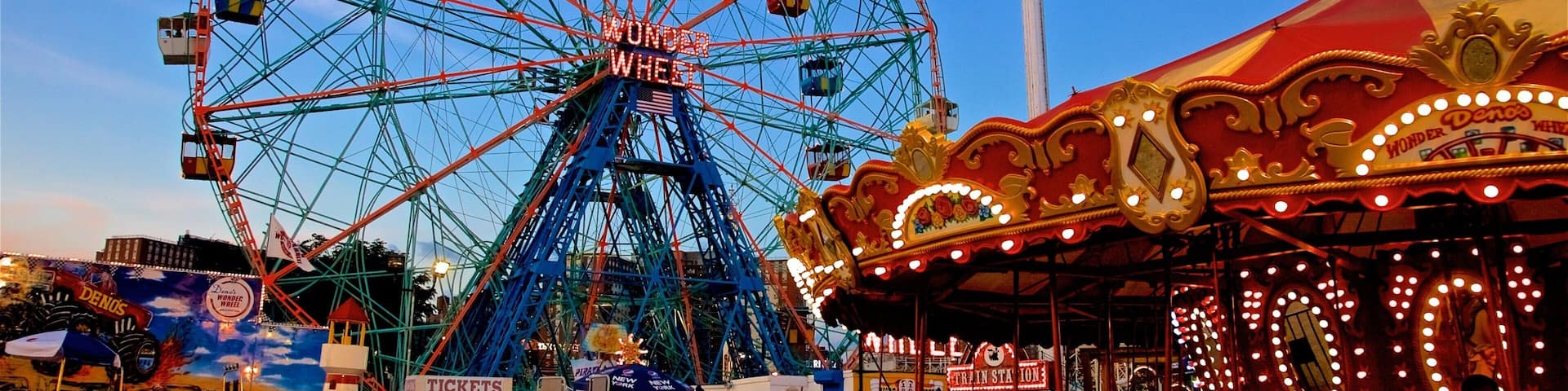 Riegelmann Boardwalk which includes rides and a sunset