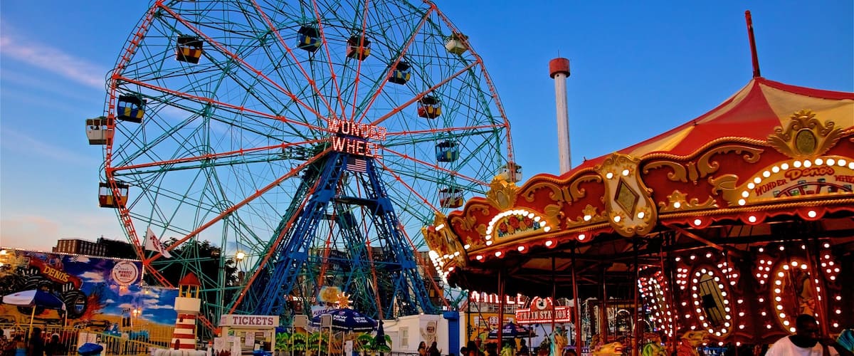 Riegelmann Boardwalk which includes rides and a sunset