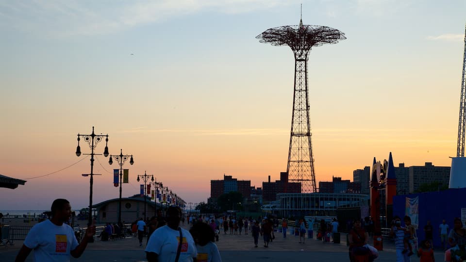 A sunset with a tall tower in the background.