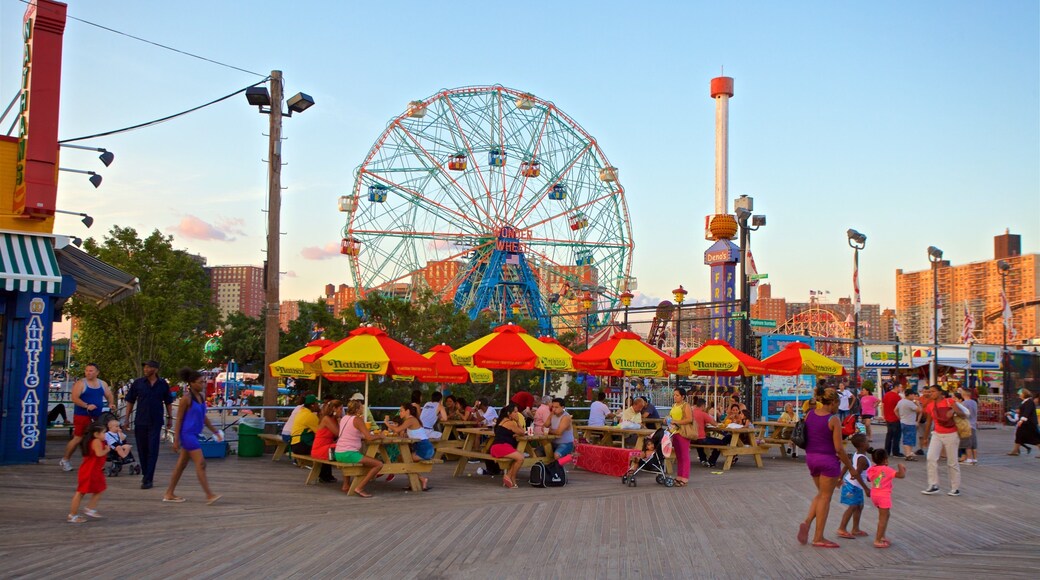Riegelmann Boardwalk which includes a sunset and outdoor eating as well as a small group of people