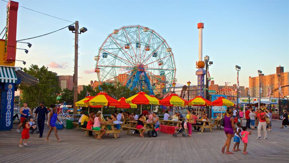 A boardwalk with picnic tables and umbrellas, a Ferris wheel, and a food vendor named Nathan's in the background.