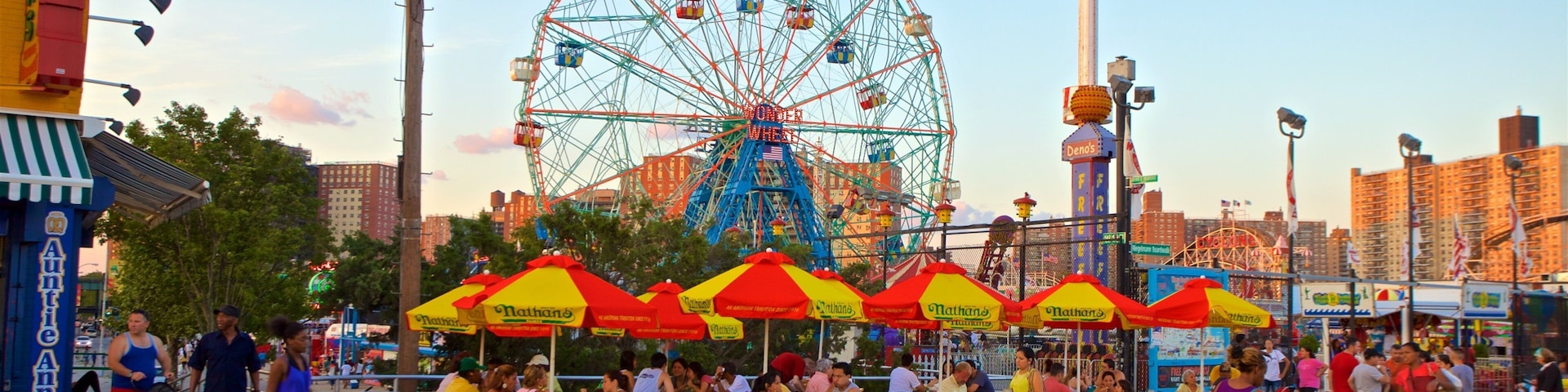 Riegelmann Boardwalk which includes a sunset and outdoor eating as well as a small group of people