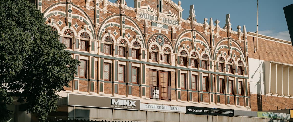 A historic building with ornate architecture, including arched windows and decorative elements.