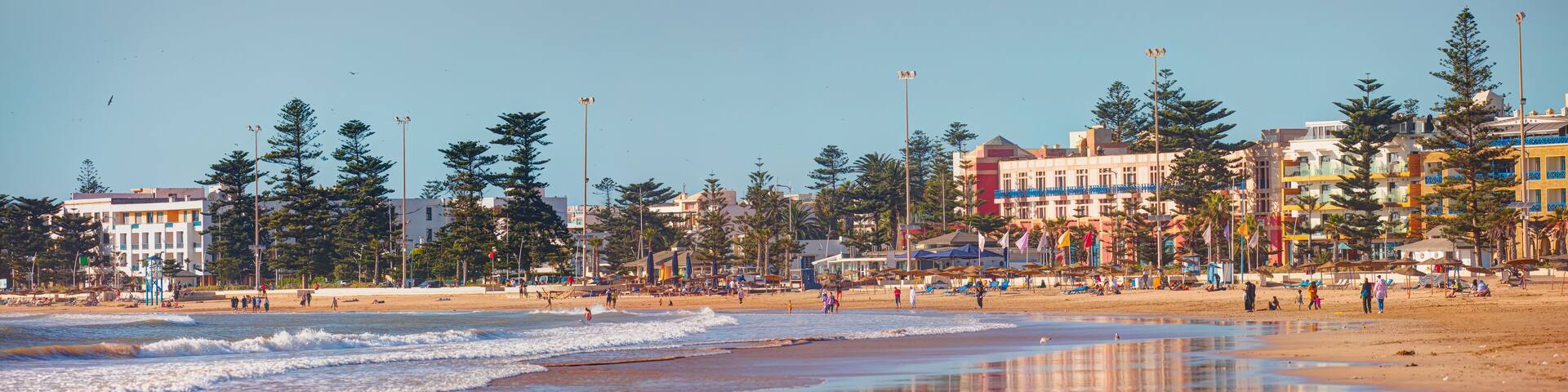 General view of the city beach with holidaymakers on the beach - Essaouira, Morocco