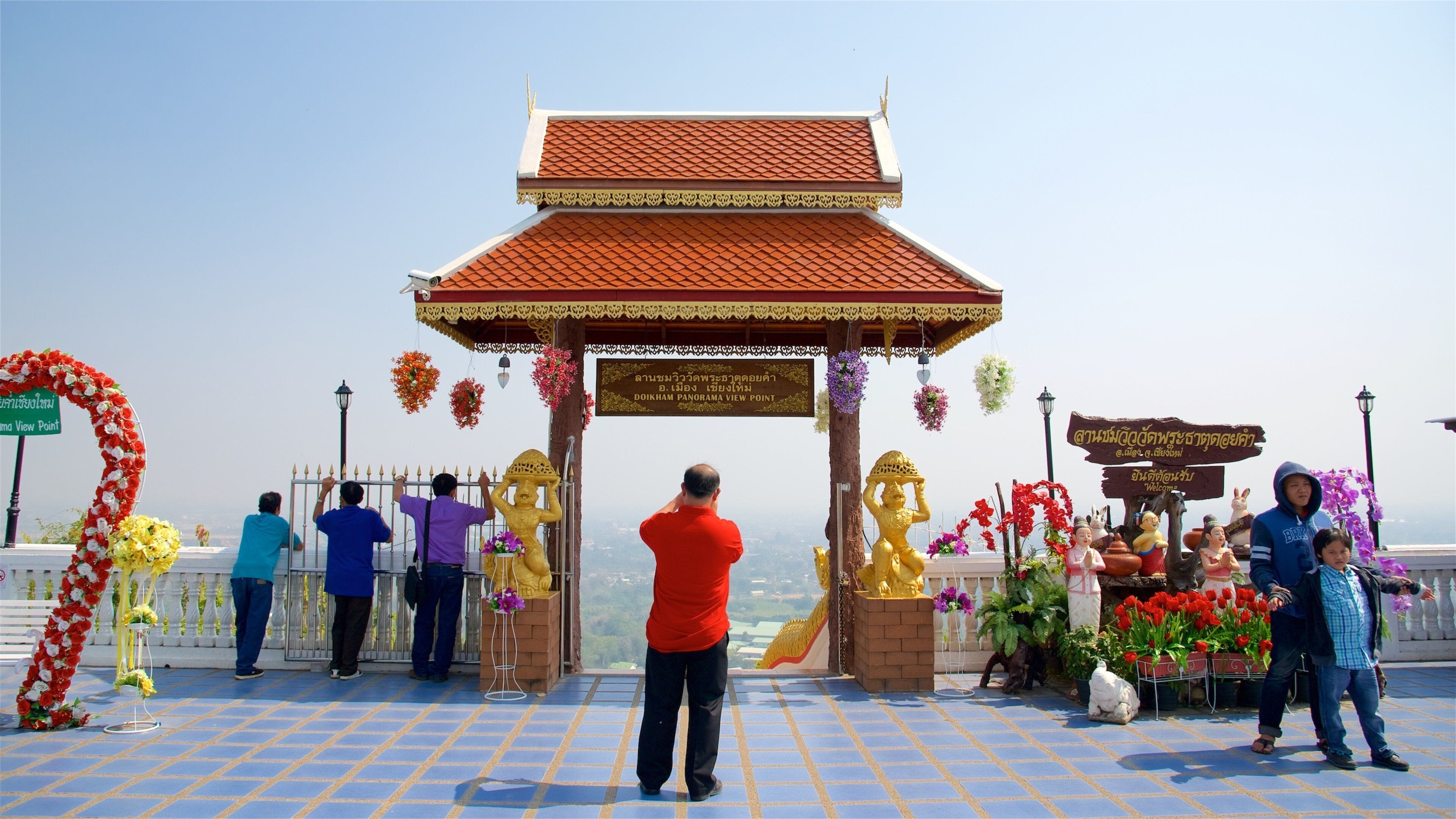 Wat Phra That Doi Kham showing heritage elements and views as well as a family