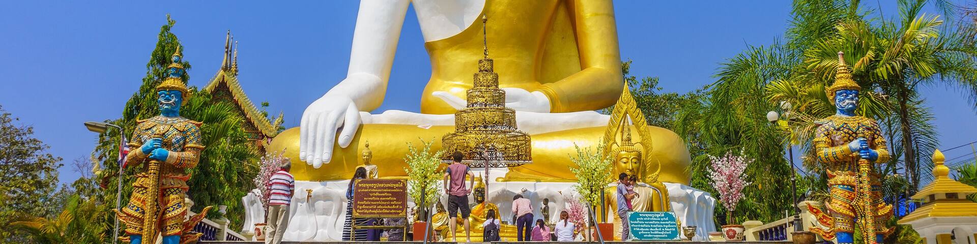 Thai pilgrims worship the big sitting Buddha statue at Wat Phra That Doi Kham. It is a landmark in Tambon Mae Hia, Amphoe Mueang.