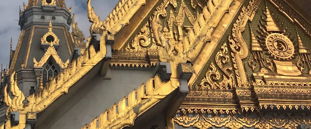 A temple with ornate golden decorations and a spire.