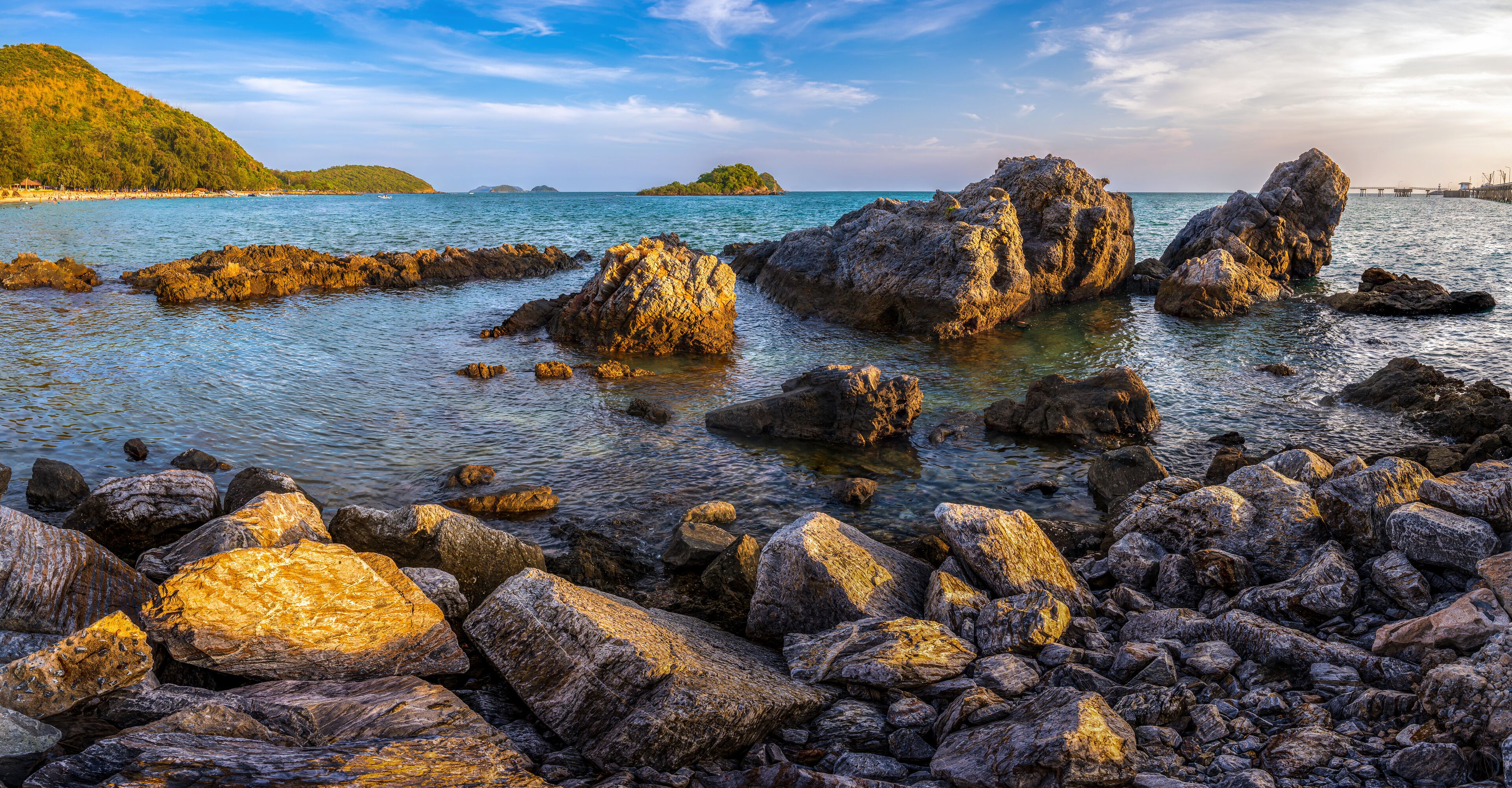 View of Nang Rong Beach with mountain and blue sky on holiday at Sattahip, Chonburi, Thailand.