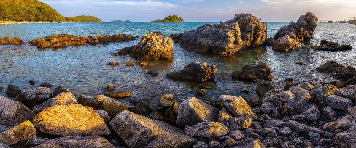View of Nang Rong Beach with mountain and blue sky on holiday at Sattahip, Chonburi, Thailand.