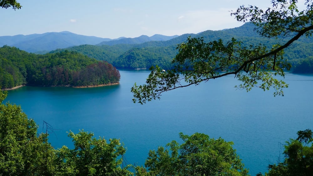 A lake surrounded by forested hills.