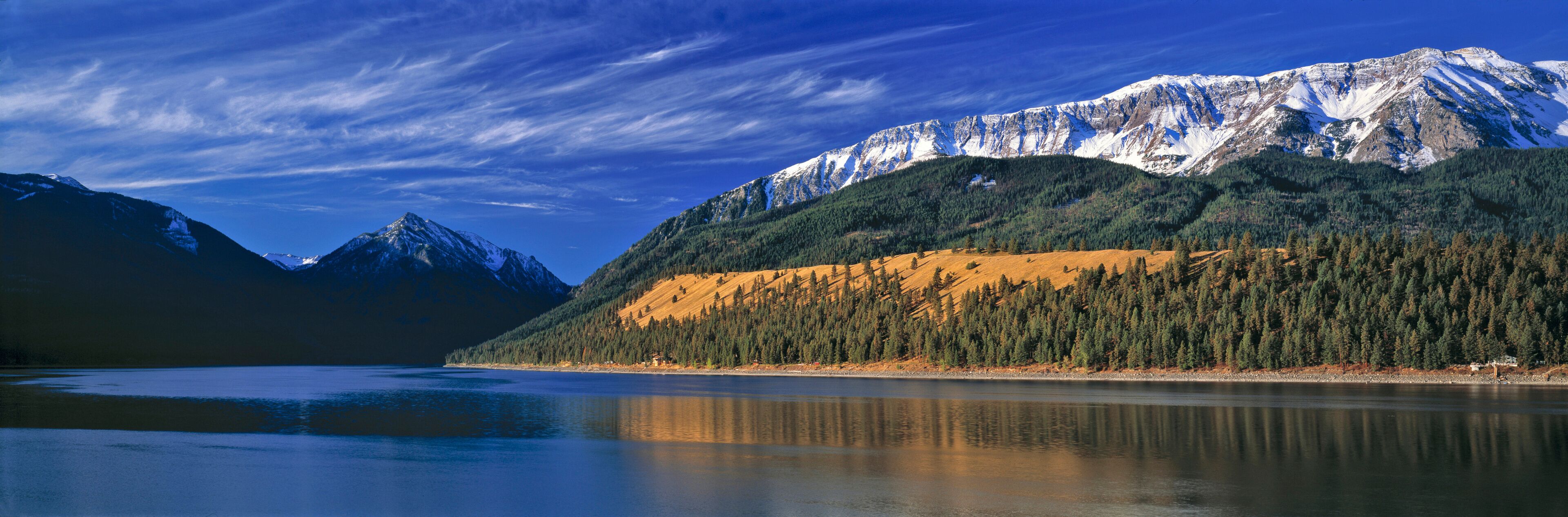USA, Oregon, Wallowa Lake. Light snow covers the Wallowa Mountains in northeastern Oregon as autumn colors the grasses above Wallowa Lake.