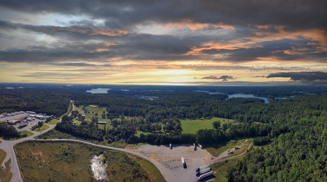 a stunning aerial panoramic shot of the blue waters of Lake Hartwell surrounded by vast miles of lush green trees and grass with powerful clouds at sunset in Fair Play South Carolina USA
