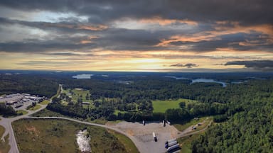 a stunning aerial panoramic shot of the blue waters of Lake Hartwell surrounded by vast miles of lush green trees and grass with powerful clouds at sunset in Fair Play South Carolina USA