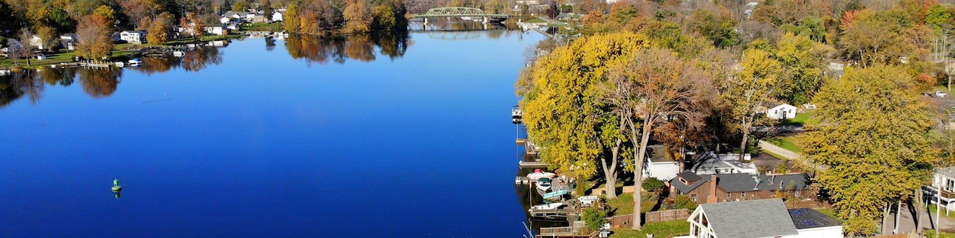 The aerial view of the waterfront homes by Oneida Lake with stunning fall foliage near Syracuse, New York, U.S.A