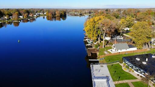 The aerial view of the waterfront homes by Oneida Lake with stunning fall foliage near Syracuse, New York, U.S.A
