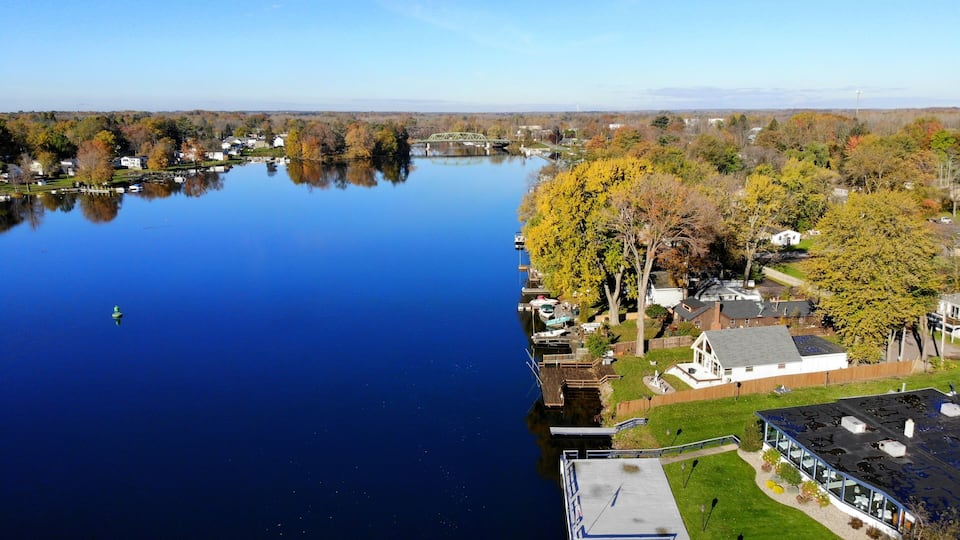 The aerial view of the waterfront homes by Oneida Lake with stunning fall foliage near Syracuse, New York, U.S.A
