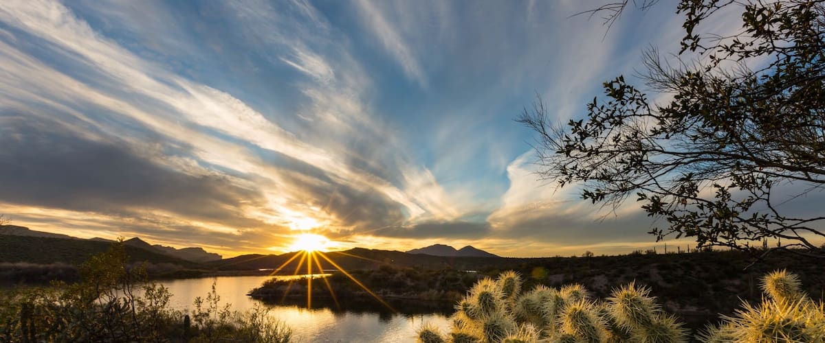 Sun star over saguaro lake in the desert of AZ