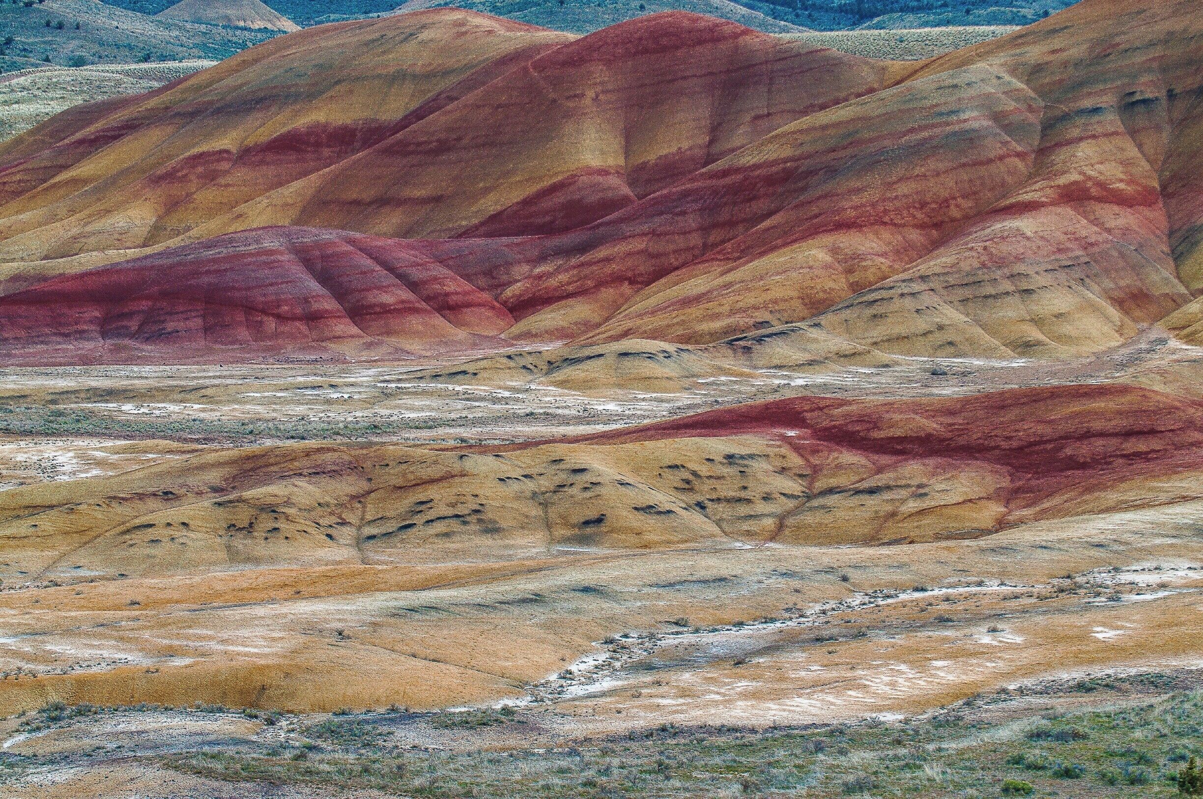 The Painted Hills is one of the three units of the John Day Fossil Beds National Monument, located in Wheeler County, Oregon and is one of the 7 Wonders of Oregon. This is truly a sight everyone should see, millions of years of history revealed in the layers of mountains of earth, one color at a time. 