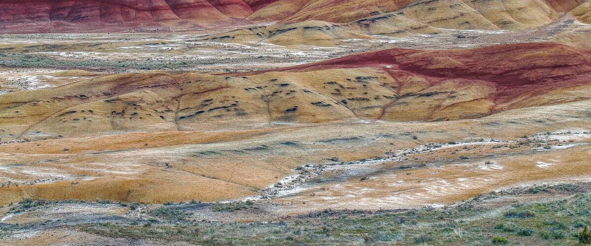 The Painted Hills is one of the three units of the John Day Fossil Beds National Monument, located in Wheeler County, Oregon and is one of the 7 Wonders of Oregon. This is truly a sight everyone should see, millions of years of history revealed in the layers of mountains of earth, one color at a time.