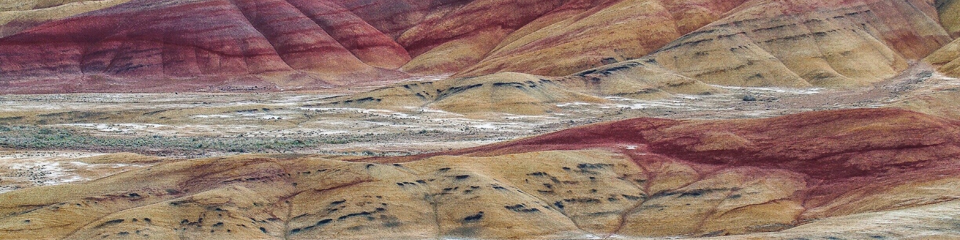 The Painted Hills is one of the three units of the John Day Fossil Beds National Monument, located in Wheeler County, Oregon and is one of the 7 Wonders of Oregon. This is truly a sight everyone should see, millions of years of history revealed in the layers of mountains of earth, one color at a time.
