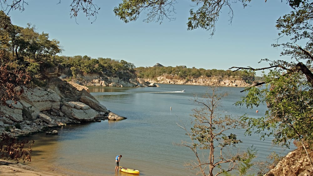 View of Lake Texoma at Eisenhower State Park outside Denison Texas and a man putting on his life vest to go kayaking.; Shutterstock ID 46891936; Purchase Order: -