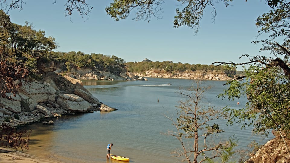 View of Lake Texoma at Eisenhower State Park outside Denison Texas and a man putting on his life vest to go kayaking.; Shutterstock ID 46891936; Purchase Order: -