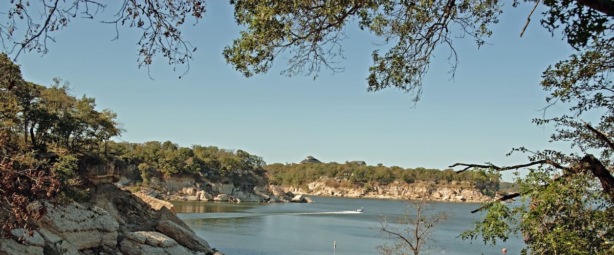 View of Lake Texoma at Eisenhower State Park outside Denison Texas and a man putting on his life vest to go kayaking.; Shutterstock ID 46891936; Purchase Order: -